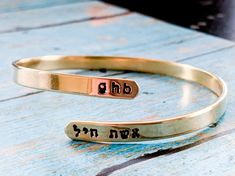 Celebrate your strength with this personalized wraparound bangle bracelet. Fashioned in brass, sterling silver, 14K gold filled, or 14K rose gold filled, this meaningful design showcases a trendy, sleek wraparound design. Complete this look with two names or phrases of your choice - each up to seven characters in length - inscribed in a tiny English and Hebrew font. FEATURES Adjustable - just slip on like a bangle bracelet and give a gentle squeeze 4.5-5mm wide Choose your wrist size and I will Adjustable Bangle Bracelets For Anniversary, Adjustable Jewelry For Anniversary Gift, Mother's Day Bracelet Jewelry For Anniversary Gift, Customizable Adjustable Jewelry, Anniversary Jewelry Bracelet, Meaningful Anniversary Jewelry Bracelet, Mother's Day Anniversary Gift Jewelry Bracelet, Personalized Adjustable Cuff Bracelet, Personalized Name Bangle Jewelry