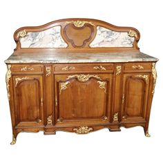 an old fashioned wooden dresser with marble top