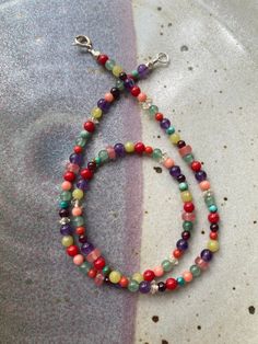 "Inspired by glass Mardi Gras beads thrown in New Orleans in the 1970s and 80s - This Semiprecious Gemstone Beaded Necklace is made with high quality multicolored stones measuring 3mm and 4mm round and approximately 4x2mm and 5x3mm diameter rondelle.   The color and stone combination of this necklace is thoughtfully designed with love by me. I choose each stone carefully and hand string all components on flexible wire which creates an extremely durable and comfortable necklace that will not stre Rainbow Beaded Necklaces With Natural Stones, Colorful Natural Stone Beaded Necklaces With Round Beads, Rainbow Gemstone Beaded Necklaces For Healing, Colorful Beaded Necklaces With Natural Stones, Multicolor Czech Glass Gemstone Beads, Multicolor Beaded Crystal Necklaces For Healing, Multicolor Czech Glass Crystal Necklaces With Round Beads, Multicolor Polished Beads Spiritual Gemstones, Spiritual Multicolor Polished Gemstone Beads