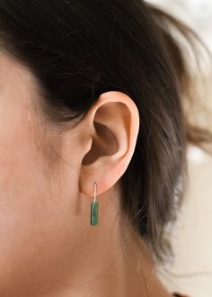 𝗘𝗮𝘀𝘆 𝗧𝗼 𝗦𝘁𝘆𝗹𝗲, 𝗠𝗮𝗱𝗲 𝗧𝗼 𝗟𝗮𝘀𝘁 Our dainty earrings are easy to pair and ready to be worn on repeat! Created to last a lifetime, these earrings will remain evergreen even as the years and trends come and go. 𝗠𝗮𝘁𝗲𝗿𝗶𝗮𝗹𝘀 𝗪𝗲 𝗨𝘀𝗲 These drop earrings are made entirely with sturdy 14k yellow gold filled pieces. They are safe to wear in the shower, but we recommend avoiding prolonged exposure to chemicals like chlorine to keep your earrings like new! These earrings are mad Minimalist Single Green Earring, Everyday Green Lever Back Earrings, Green Minimalist Sterling Silver Earrings, Everyday Green Sterling Silver Earrings, Minimalist Green Sterling Silver Earrings, Classic Everyday Earrings For May Birthstone, Dainty Green Earrings For Everyday, Green Minimalist Pierced Earrings, Minimalist Green Pierced Earrings