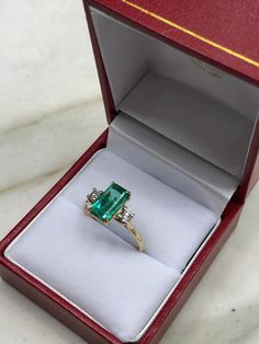 A classic Colombian emerald and diamond engagement, statement, or right-hand ring. Dexterously crafted in gleaming 14K gold this ring features a 1.70-carat natural Colombian emerald-emerald cut from the famous Chivor mines. Set in a secure prong setting, this extraordinary emerald has a bright green color and glow. This emerald has very good eye clarity with natural Jardins that occur in all earth-mined emeralds. Brilliant round diamonds weighing 0.22pts total accent either side of the emerald. Remembrance Rings, Colombian Emerald Engagement Ring, Emerald Jewelry Ring, Diamond Ring Emerald, Black Diamond Wedding Rings, 3 Stone Ring, Dream Rings, Rose Gold Morganite, Emerald Diamond Ring