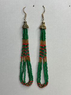 Made of glass seed beads and strong nylon B thread string, this pair is hung on sterling silver posts. Festival Multi-strand Dangling Beads Jewelry, Multi-strand Dangling Beads Festival Jewelry, Festival Multi-strand Jewelry With Dangling Beads, Adjustable Green Beads With Silver Accents, Green Dangling Beads Earrings For Festivals, Traditional Green Beaded Earrings For Festivals, Dangling Beads For Gifts And Festivals, Dangling Multi-strand Beads For Gifts, Multi-strand Dangling Beads For Gift