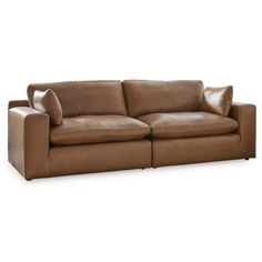 a brown leather couch sitting on top of a white floor