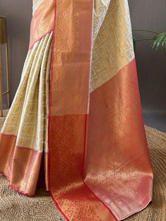 Wear this stunning off-white silk saree with peach color blouse adorned with intricate zari weaving work to make a fashionable statement at any festival, function, or wedding. The saree and unstitched blouse material come in a length of 5.50 meters, allowing you to drape it elegantly to showcase the beautiful zari work.
The off-white color adds a touch of sophistication, while the peach blouse complements the saree perfectly. This glamorous saree include the luxurious silk material that drapes e White Pre-draped Saree With Zari Weaving For Festivals, White Katan Silk Pre-draped Saree With Pallu, White Tussar Silk Pre-draped Saree For Diwali, White Banarasi Silk Saree With Zari Weaving, Festival Off-white Pre-draped Saree With Cutdana, White Katan Silk Saree With Zari Weaving, White Saree With Zari Weaving, White Banarasi Silk Saree With Cutdana, White Tussar Silk Saree With Zari Weaving