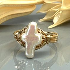 "White Cultured Pearl Cross and Sterling Silver, Yellow or Rose Gold Filled Wire Wrapped Ring; Custom Made to Size *This white cultured pearl cross bead and wire wrapped ring is handmade with an approximately 9mm by 13mm pearl bead and your choice of wire type for the band. *This ring (as well as all the others in my shop) is custom made to any size from 4 to 14 including half and quarter sizes! DIRECTIONS FOR CHECKOUT 1.) To checkout, please select the SIZE of the ring and your choice of BAND C Ring With Wire, Silver Wrap Ring, Preppy Jewelry, Wire Wrapped Ring, Jewelry Accessories Ideas, Dope Jewelry, Jewelry Essentials, Wire Rings, Cross Ring