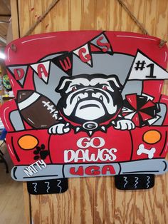 a sign with a pug driving a red car that says go dawgs