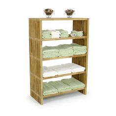 a bamboo shelf with three shelves filled with baby blankets