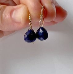 Our dainty genuine sapphire drop earrings are the perfect lightweight, simple, everyday dangling earring. The sparkling genuine sapphire gemstones make a minimalist statement. They make a great birthstone earring gift as we offer a choice of every month's birthstone as well as other popular gemstones in the drop-down menu. Sapphire is the September birthstone. We also offer these earrings in gold filled, sterling silver, rose gold, and 14k gold. The model is wearing the sapphire November birthstone earrings in 14k gold filled. CRAFTSMANSHIP  Jewelry is handmade by us in our NYC studio. We focus on craftsmanship and quality using only the highest quality materials and handpicked genuine gemstones.  PACKAGING We take pride in creating beautifully packaged orders. Jewelry arrives delicately w Minimalist Briolette Hypoallergenic Earrings, Minimalist Hypoallergenic Briolette Earrings, Teardrop Sapphire Earrings For Gift, Dainty Everyday Gemstone Earrings, Everyday Gemstone Drop Earrings, Sapphire Teardrop Gemstone Earrings, Sapphire Teardrop Earrings With Ear Wire, Classic Gemstone Earrings For Everyday, Classic Everyday Gemstone Earrings