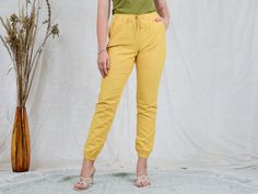 "AUNT GERTRUDE PRESENTS - vintage yellow linen pants - elastic waist - 2 pockets - materials: linen CONDITION (1-10 ❶❷❸❹❺❻❼❽❾ Great condition. SIZE/MEASUREMENTS size from label: EUR 38, FR 40, GB 10 best fits: M/L waist: 31,5-39,5 inches (80-100 cm) hips: 39,5 inches (100 cm) rise: 10 inches (25 cm) length: 39,5 inches (100 cm) inseam: 31 inches (78 cm) The model is 5'9\" (174 cm), measures 35-27-38 (90-69-96 cm) and wears size M" Casual Yellow Pants, Yellow Straight Pants With Elastic Waistband, Yellow Pants With Elastic Waistband, Casual Yellow Ankle-length Bottoms, Casual Yellow Ankle-length Pants, Yellow Ankle-length Pants With Elastic Waistband, Yellow Relaxed Fit Ankle-length Pants, Yellow Relaxed Fit Straight Pants, Relaxed Fit Yellow Pants With Pockets