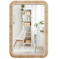 a white chair sitting in front of a mirror on top of a wooden shelf next to a window