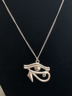 Eye of Horus charm necklace, Egyptian Eye necklace, on custom length chain. The charm is zinc alloy (lead, nickel, and cadmium free). The chain is hypoallergenic 304 stainless steel which is incredibly strong and anti tarnish, similar to surgical steel so many people can wear it, including many of those with sensitive skin. Please choose your length of chain from 13-30 inches from the drop-down variation menu. There is a necklace length guide shown in photos. I always put the clasps on the right hand side but if you are a lefty or if you would like the clasp on the left side please send me a message. GIFT READY! This necklace will come with the gift box, gift wrapped in tissue and inside of the bubble mailer shown in photos. Please keep jewelry out of reach of small children. Thanks so muc Symbolic Silver Alloy Jewelry, Personalized Silver Metal Necklace, Symbolic Metal Jewelry With Adjustable Chain, Silver Charm Necklace In Alloy, Antique Silver Chain Necklace For Gift, Symbolic Personalized Metal Jewelry, Personalized Symbolic Metal Jewelry, Personalized Silver Metal Charm Necklace, Silver Charm Chain Necklace