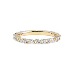 a yellow gold band with white stones