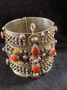 A beautiful authentic antique bracelet of the Beni Yenni, Kabylia, Algeria. Perfect condition. High grade silver, blue and yellow enamel and mediterranean red coral. The bracelet has a weight of 202 grams! Diameter : 6 cm Height : 6,5 cm Antique Blue Bracelet Jewelry, Blue Intricate Design Jewelry Bracelet, Unique Heavy Jewelry For Ceremonial Use, Traditional Hallmarked Jewelry For Collectors, Unique Heavy Jewelry For Ceremonial Occasions, Vintage Blue Ceremonial Jewelry, Bohemian Hallmarked Bangle Jewelry, Ornate Bangle Bracelet For Festival, Ornate Bracelet Jewelry For Festivals