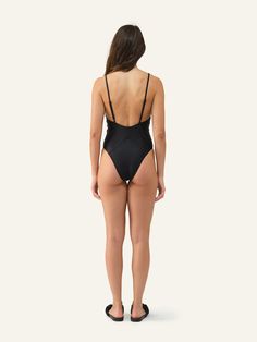 Striking one-piece swimsuit featuring a plunging neckline and detailed binding accents. High leg rise with cheeky rear coverage and adjustable straps. Plunge Swimsuit, High Leg, Plunging Neckline, One Piece Swimsuit, Binding, Adjustable Straps, Comfort Fit, Spring Summer, One Piece