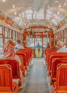 people are sitting on the inside of a bus