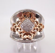 a close up of a ring with diamonds on it's sides and in the middle