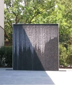 a large water fountain in front of a building