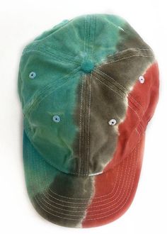 a tie dye baseball cap with buttons on the front and back side, sitting on a white surface