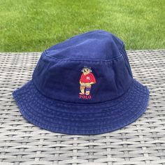 Vintage Navy/White/Beige/Black Polo Bear Bucket Hat Iconic embroidered Fisherman Polo Bear image wearing a cute blue bucket hat 🧸 Diameter of the inside of the hat is roughly 22-24in varying slightly with each hat One size fits all, perfect for festivals, raves or any event where you need to look like a baller Free Shipping Included with every purchase 🚀 No returns on sizing issues Bear Bucket Hat, Fishing Bear, Bear Fishing, Blue Bucket Hat, Bear Images, Cotton Bucket Hat, Black Bucket Hat, Summer Beach Vacation, Black Bucket