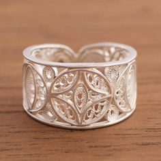 Crafted by hand with intricate sterling silver filigree scrollwork this elegant band ring evokes the beauty of the moon. Peruvian artisan Alfredo Inga designs the ring which accentuated by a combination of finishes. Elegant Filigree Toe Ring With Intricate Design, Adjustable Bohemian Engraved Ring With Intricate Design, Elegant Adjustable Engraved Filigree Ring, Elegant Engraved Adjustable Filigree Ring, Ornate Adjustable Rings With Intricate Design, Elegant Silver Carved Filigree Ring, Ornate Sterling Silver Filigree Ring With Intricate Design, Elegant Adjustable Filigree Ring With Intricate Design, Adjustable Filigree Ring With Intricate Design