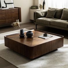 a coffee table with two vases on it