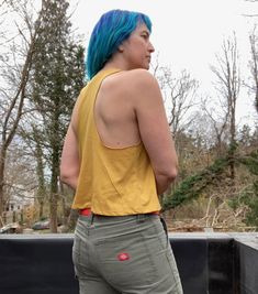 "this is my go to workout top as it pairs well with leggings for my yoga, barre or running workouts. i print my snake design in black on this ultra cool yellow tank which has nice open armholes for venting all that sweat and to show off your arms! COLOR: saffron S: chest 34\", length 19\" M: chest 36, length 20\" L: chest 38\", length 21\" XL: chest 40-42\", length 23\" i'm wearing the medium in the photos above. i'm 5'7\", 145 lbs and a 35\" bust" Yellow Stretch Casual Activewear, Casual Yellow Activewear For Light Exercise, Casual Racerback Crop Top For Light Exercise, Casual Yellow Activewear For Yoga, Yellow Stretch Tops For Workout, Casual Yellow Activewear For Workout, Yellow Racerback Tank Top Casual Style, Yellow Stretch Top For Workout, Yellow Athleisure Tops For Gym