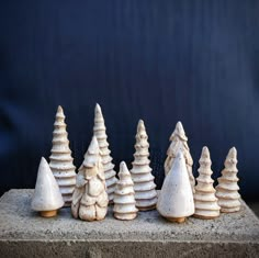 a group of small white trees sitting on top of a cement block