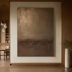 an abstract painting hangs on the wall next to a dining room table