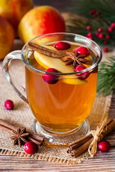 a glass mug filled with apple cider and cinnamon