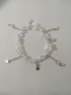 a white bracelet with charms and beads