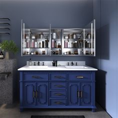 a bathroom with two sinks and blue cabinets