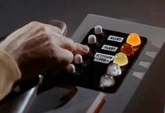 a person's hand is pressing buttons on a button board with several different colors