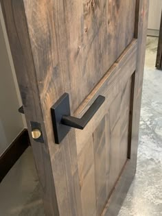 a wooden door with metal handles on the front and side doors that are made out of wood