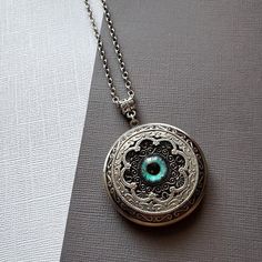 Large Locket Dragon Eye Necklace ☻Locket ~ Large, Decoratively Styled ~ Measures 1.77 inches round See Photos for size comparison against American quarter Chain: ~ Silver Plated YOU CHOOSE YOUR CHAIN LENGTH during checkout ☻More Lockets Here: https://www.etsy.com/shop/FashionCrashJewelry/search?search_query=lockets&order=date_desc&view_type=gallery&ref=shop_search ☻Link to The ENTIRE SHOP: https://www.etsy.com/shop/FashionCrashJewelry?ref=shopsection_shophome_leftnav&ga_search_qu Vintage Round Pendant Jewelry For Festivals, Antique Silver Spiritual Jewelry, Vintage Locket Jewelry For Festivals, Handmade Antique Silver Pendant Locket Necklace, Vintage Festival Locket Jewelry, Bohemian Engraved Round Locket Necklace, Bohemian Handmade Jewelry For Keepsake, Handmade Bohemian Keepsake Jewelry, Bohemian Handmade Keepsake Jewelry