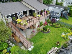 an aerial view of a house with a deck and stairs leading up to the second floor