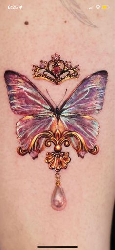 the back of a woman's shoulder with a butterfly tattoo on it and a water drop