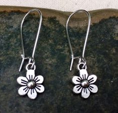 "These are just so sweet and cute! Little daisy dangle earrings. Perfect addition to any outfit and sure to brighten your day! Made from allergy free plated silver. The flowers measure 1/2\" long by 3/8\" wide and hang from 1\" kidney style ear wires that lock and latch. Overall drop length is 1 1/2\". Thanks for stopping by! Please take a moment and visit the rest of my Etsy shop. I have many more unique jewelry designs to choose from! 🌸 Tiger Flower Jewelry 🌸 🌸 Inspired by Nature 🌸" Tiger Flower, Flower Earrings Silver, Small Flower Earrings, Sterling Silver Flower Earrings, Vintage Drop Earrings, Daisy Pendant, Daisy Jewelry, Silver Flower Earrings, Butterfly Earrings Stud