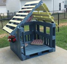 a wooden toy house made out of pallets