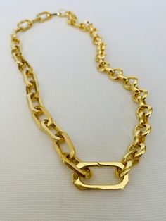 This versatile necklace offers three different looks in one stunning piece of jewelry. Crafted with a combination of two gold chains, including a gold paper clip chain and round rolo chain, it is finished with a connector clasps. The necklace measures approximately 17 inches in length and can be rotated to achieve three distinct styles. In the first look, you can showcase the bold statement necklace by wearing it with the gold paper clip chain prominently displayed. The unique and contemporary d Gold Double Chain Link Necklace, Gold Link Chain Necklace With Double Chain, Gold Toggle Necklace With Paperclip Chain, Chic Gold Toggle Necklace With Paperclip Chain, Gold Chic Toggle Necklace With Paperclip Chain, Gold Toggle Necklace With Chain Link, Gold-tone Double Chain Link Necklace, Gold Toggle Chain Link Necklace, Everyday Gold Toggle Link Necklace