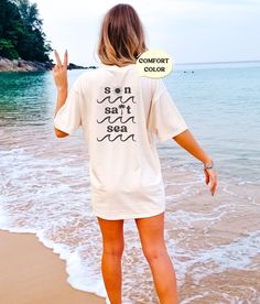 These cute beachy, distressed tees make a perfect beach coverup or lounge tee! Or mix and match colors with friends for a perfect group vacation photo! Please note that this design comes in black ink only, and is only on the back of the tshirt! About Comfort Colors Tees! (Unisex Shirts!) These ultra soft pigment dyed shirts are one of our best sellers ⭐️ 100% ring spun cotton ⭐️ PRESHRUNK, soft-washed, garment-dyed fabric ⭐️ Set-in sleeves ⭐️ Double-needle stitched sleeves and bottom hem ⭐️ Twill taped shoulder-to-shoulder ⭐️ 1" ribbed collar with double-needle topstitched neckline HOW TO PLACE AN ORDER 1. View all color and size charts before you place your order. 2. Select your shirt "SIZE" and "COLOR". 3. Click add to cart **Repeat process for each tshirt WASHING INSTRUCTIONS Use cold w Relaxed Summer T-shirt For Loungewear, Relaxed Summer Loungewear T-shirt, Relaxed Short Sleeve T-shirt For Vacation, Oversized Casual T-shirt For Beach Season, Oversized Cotton T-shirt For Vacation, Relaxed Beach Cover-up Tops, Oversized Summer Beach Cover-up Top, Casual Vacation T-shirt With Relaxed Fit, Oversized Summer Top For Beach Cover-up