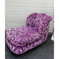 a purple chair sitting in front of a garage door