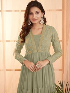 This elegant Green Sequins and Embroidered Tiered Maxi Dress features a floral embroidered design, fit and flare shape, and a flattering V-neckline. Its long regular sleeves and flared hem add a touch of sophistication, while the slip-on closure allows for easy dressing. Perfect for any formal occasion, this dress is a Anarkali V-neck Dress With Floral Embroidery, Long Sleeve Embroidered Dress For Eid, Long Sleeve Floral Embroidered Dress For Eid, Elegant Dress With Embroidered Long Sleeves, Elegant Long Sleeve Dress With Embroidered Sleeves, Long Sleeve Embroidered Floral Wedding Dress, Long Sleeve Embroidered Wedding Dress With Floral Details, Long Sleeve Wedding Dresses With Floral Embroidery, Intricate Embroidered Long Sleeve Dress For Eid