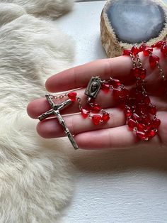 This gorgeous vintage Rosary features a cross that is stamped Made in Italy on the back. This piece is beaded with red heart beads throughout. It has very minor wear and is in overall great shape. The Rosary would make a great addition to anyone's collection. The chain is 20 inches in length The cross measures 1.5 inches long Red Crucifix Cross Necklace For Gift, Red Crucifix Cross Necklace Gift, Beaded Crucifix Rosary As Gift, Handmade Red Rosary With Cross, Handmade Red Cross Rosary, Handmade Red Rosary, Vintage Rosary With Cross Pendant Gift, Red Crucifix Rosary As Gift, Catholic Christmas