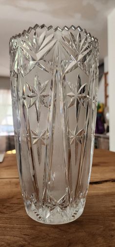 a clear glass vase sitting on top of a wooden table