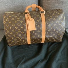 Louis Vuitton Keepall Bandouliere Shoulder Bag 45 Brown Leather. In New like condition. Great bag for travel or a little extra personality. Strap can not be added. Price is firm. This is not a resale item, it is my personal item and price is non-negotiable. Thank You for your consideration. Blessings High-end Tan Travel Bags, Louis Vuitton Keepall 25, Travel Bag In Monogram Canvas With Original Box, Designer Tan Travel Bag, Designer Travel Bag With Top Carry Handle, Designer Brown Travel Bag With Top Carry Handle, Large Capacity Monogram Canvas Travel Bag, Designer Brown Bag For Trips, Designer Brown Bags For Business Trips