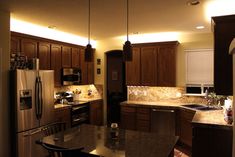 a kitchen with wooden cabinets and granite counter tops, along with an island in the middle