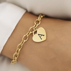 Introducing our 18k Disc Gold Plated Initial Bracelet--a perfect blend of elegance and personal flair. This stunning bracelet features a delicate heart pendant, measuring 20mm x 20mm, crafted from 18k gold-plated stainless steel. Whether you're treating yourself or finding a special gift, this piece combines timeless charm with modern durability. This bracelet is not only a stylish accessory but also practical. It's waterproof and hypoallergenic, making it a great choice for everyday wear. The 1 Elegant Bracelets With Heart Charm, Elegant Bracelets With Heart Charm For Personalized Gift, 14k Gold-tone Charm Bracelet As Gift, Classic Heart Bracelet For Valentine's Day Gift, Elegant Everyday Charm Bracelet For Valentine's Day, Classic Heart Pendant Bracelet As Gift, Classic Heart Shaped Chain Bracelet As Gift, Classic Bracelets With Charms For Valentine's Day, Classic Heart-shaped Chain Bracelet As Gift