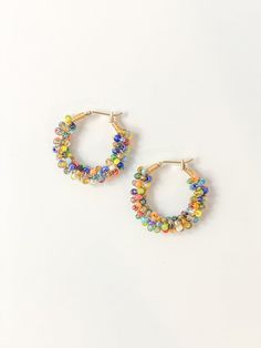 Make a statement with our signature Angler Hoops - hand-beaded and ready to add a bold splash of color to your look. These vibrant, handcrafted pieces will have you hooked! Now, the only question remaining is: how many hues will you choose? Due to the handmade nature of these earrings, expect small variations and imperfections that make your pair unique. Glass seed beads Gold-plated hoop 1.25" diameter Colorful Beaded Hoop Earrings For Beach, Turquoise Hoop Earrings With Colorful Beads, Rainbow Hoop Earrings With Colorful Beads, Turquoise Dangle Hoop Earrings With Colorful Beads, Adjustable Rainbow Hoop Earrings With Colorful Beads, Earrings Multiple, Splash Of Color, Elastic Bracelet, Adjustable Bracelet