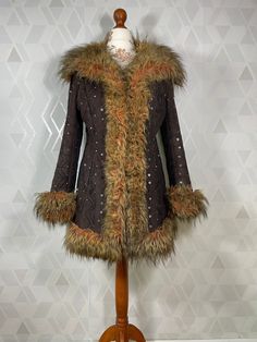 Beautiful Penny Lane jacket from the 90s with a faux suede top embroidered with thread and sequins. It is trimmed with an interesting thick colored fur, beautifully fitted. The jacket is in very good condition. Dimensions: sleeve from the collar: 71 cm sleeve from the armpit: 41 cm in the bust: 2x 48 cm waist: 2x 44 cm total length: 73 cm Our mannequin is in size M Size from tag: 36 Fitted Fur Coat With Faux Fur Trim, Fitted Long Sleeve Fur Coat With Faux Fur Trim, Fitted Winter Fur Coat With Faux Fur Lining, Fitted Fur Coat With Faux Fur Lining For Winter, Fitted Faux Fur Winter Coat, Fitted Faux Fur Coat For Winter, Fitted Fur Coat With Faux Fur Trim For Fall, Winter Embellished Long Sleeve Outerwear, Embroidered Costume Outerwear For Fall