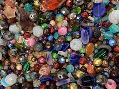 many different colored beads are scattered together